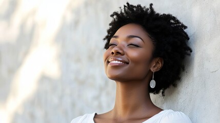 A joyful African American woman radiates happiness, embodying warmth and positivity.