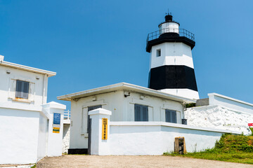 Building view of the Fuguijiao lighthouse at the northernmost proper point(North Coast and Guanyinshan National Scenic Area) in New Taipei City, Taiwan.