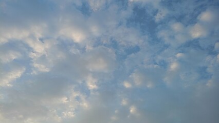 Blue sky with clouds and sun reflection.The sun shines bright in the daytime