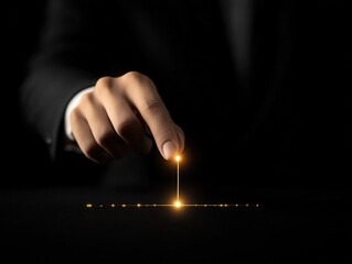 A hand reaching to touch a glowing light, symbolizing innovation and technology.