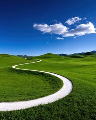 Obraz premium A winding path through lush green hills under a bright blue sky.
