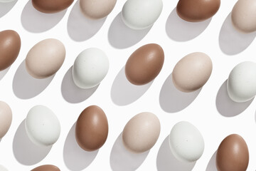 Pattern of Brown and beige Eggs with sun shadows, minimal style aesthetic holiday background, natural organic chicken eggs, breakfast ingredients,  minimalist food composition, neutral pastel color