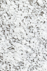 Close-up of magnesium flakes on gray concrete background, salt crystalline texture. Natural White sea salt as wellness or spa products for bath or relaxation, self-care or sustainable living