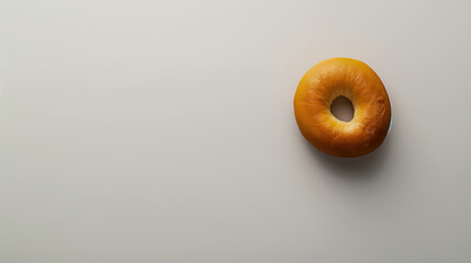 Freshly baked bagel on a clean surface ready to be enjoyed for breakfast or as a snack any time of day.