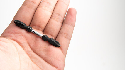 Screwdriver bit for impact driver holding with hand with negative space background