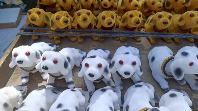 Mysuru, Karnataka, India-February 5 2025; Catchy video of Oscillating Puppy dolls, soft toys, vibrant colors to sell at Kumbha mela festival in India.