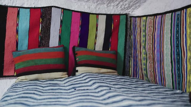Colorful Bed with Traditional Textiles in Berber Village of Matmata, Tunisia