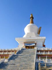 Stairway Leading to a White Stupa Against a Clear Blue Sky