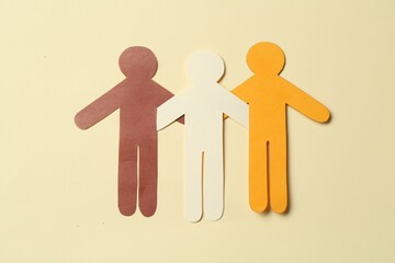 Stop racism. Paper human figures of different colors on beige background, top view
