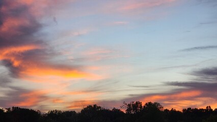 Clouds lit orange by the sunset over the lake