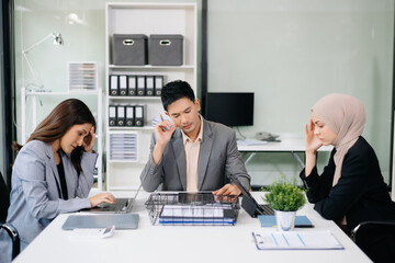 Furious Asian businesspeople arguing strongly after making a mistake at work in office