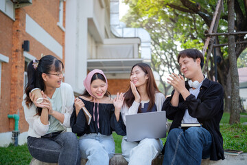 Group of happy college friends chatting aduring a break in the campus courtyard.