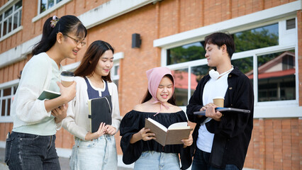 Goup of university students chatting and enjoying a study break outdoors on campus.