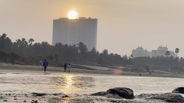 man and woman walking on the beach
