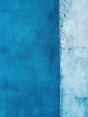 Blue wall background, half painted in blue color and the other side with a plain concrete texture. Blue color wall background