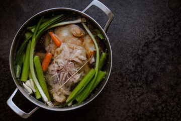Chicken Stock Preparation with Vegetables like Carrots and Celery with a Cooked Chicken and water with Seasoning for Soup or Bone Broth
