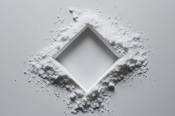 White powder forms a square shape on a plain background