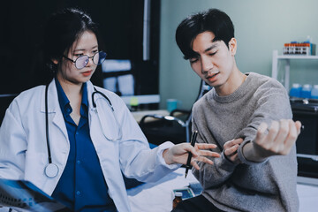 Female physician reads medical history while visiting her patient