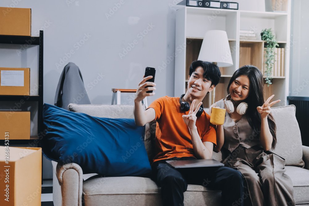 Wall mural Smiling couple unpacking boxes in new house