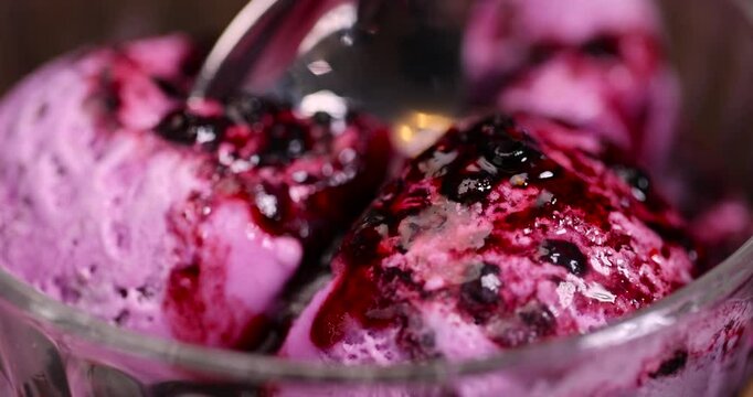 and cold purple ice cream with blueberry flavor, blueberry ice cream balls with blueberry sweet jam