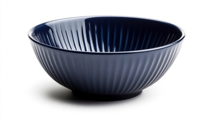 A dark blue ceramic bowl with a fluted texture, featuring a simple and elegant design, is placed on an all-white background. The bowl is slightly angled to the right
