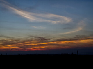 Sunset sky with dark clouds in the background