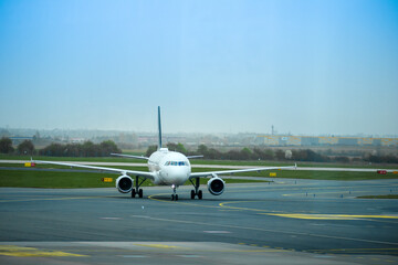 
the nose of an airplane parked on an airport runway.