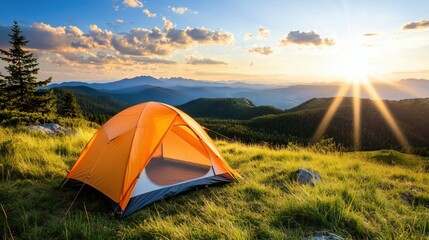 A Bright Sunrise Over a Mountain Landscape with an Orange Camping Tent in a Green Meadow Setting