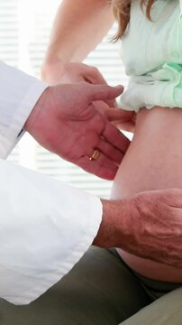 Pregnant woman being checked by a doctor