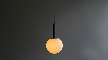 Spherical Glass Lamp with Warm Light Hanging Against Dark Gray Wall