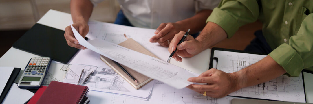 A professional engineering team working on cost estimation and resource allocation for a building project