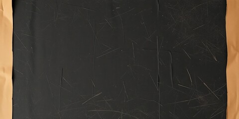 Fototapeta premium Old, wrinkled black paper with a layer of dust on top, wrapped in tattered cardboard, texture, antique, weathered