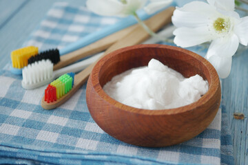 Tooth care essentials with baking soda and colorful toothbrushes