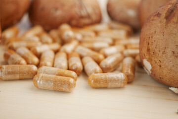 Herbal capsules and baked goods on a wooden table
