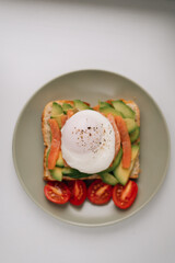 Toast with avocado, fish and poached egg