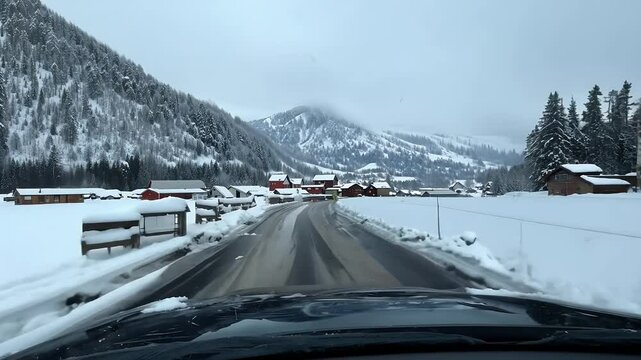 A driving experience snow covered mountain valley road point view POV winter storm rural farming community focusing seasonal cold ather snow ice road landscape