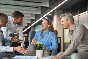 Business team discussing together business plans in office.