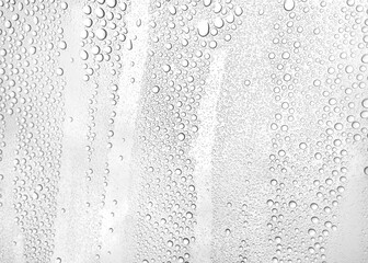 Horizontal close-up detail of water drops texture from rain on a window
