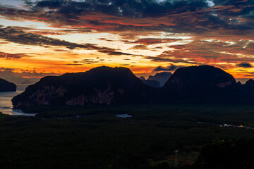 A distant natural background of a large mountain in the middle of the sea, Phang Nga Bay, Thailand, from a major viewpoint where tourists come to watch the sunrise in the morning.