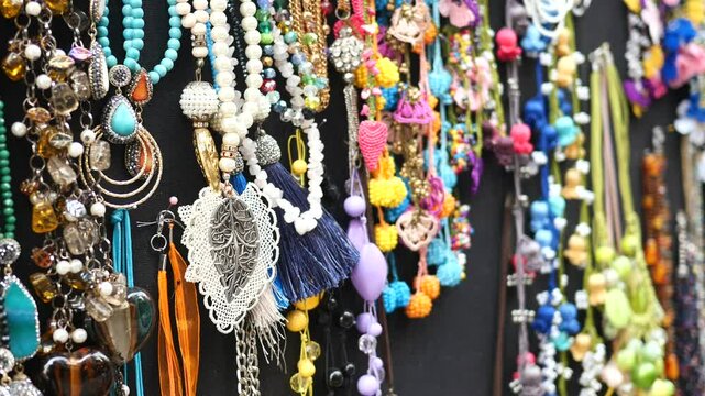 Visitors admire an array of handcrafted jewelry at a bustling market