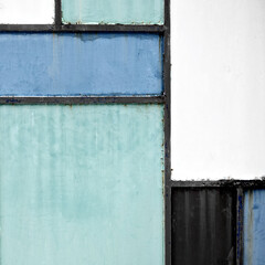 Geometric iron texture steel door background. Green, blue and grey metal sheet gate. Composition and elements of visual design. Vintage and hipster. De stijl. Close up.