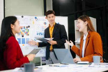 Office colleagues have a casual discussion. During a meeting in a conference room, a group of business teem