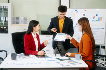 Office colleagues have a casual discussion. During a meeting in a conference room, a group of business teem