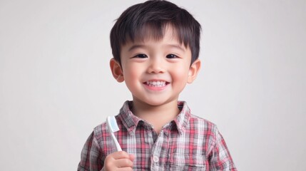 happy boy holding toothbrush smiling