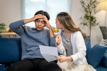 A man and a woman are sitting on a couch