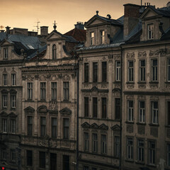 Fototapeta premium Elegant historic buildings with intricate facades bathed in warm evening light. The architecture reflects a timeless European charm, evoking nostalgia and old-world beauty.