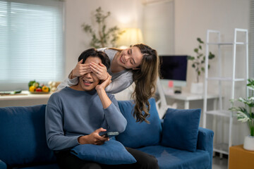 Fototapeta premium A man and a woman are sitting on a blue couch