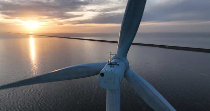 Aerial view of Wind turbines on water, wind park at the Afsluitdijk in the Netherlands at sunset