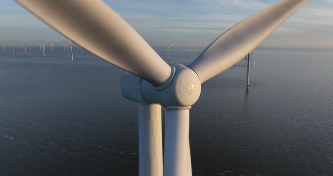 Aerial view of Wind turbines on water, wind park at the Afsluitdijk in the Netherlands at sunset