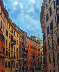 bright cityscape with colorful houses under a heavy cloudy sky.